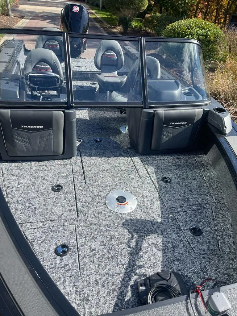 Slide: The Image of 2025 Tracker Targa V-19 WT boat interior with seating and carpeted deck. - 2