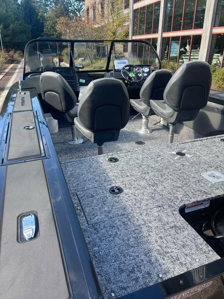 Slide: The Image of 2025 Tracker Targa V-19 WT boat interior with seating and dashboard view. - 4