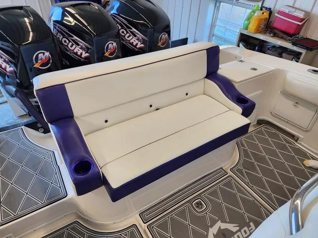 Slide: The Image of 2003 Fountain 38 Center Console boat with white and purple seating, Mercury engines. - 10