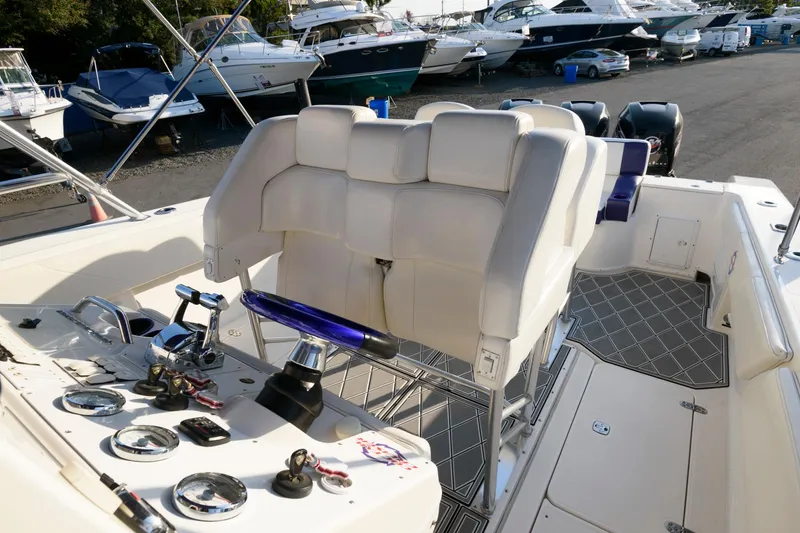 Slide: The Image of 2003 Fountain 38 Center Console boat interior with steering wheel and controls. - 16