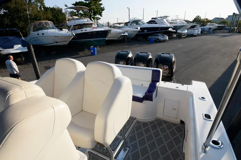 Slide: The Image of 2003 Fountain 38 Center Console boat with triple engines, docked near other boats. - 17