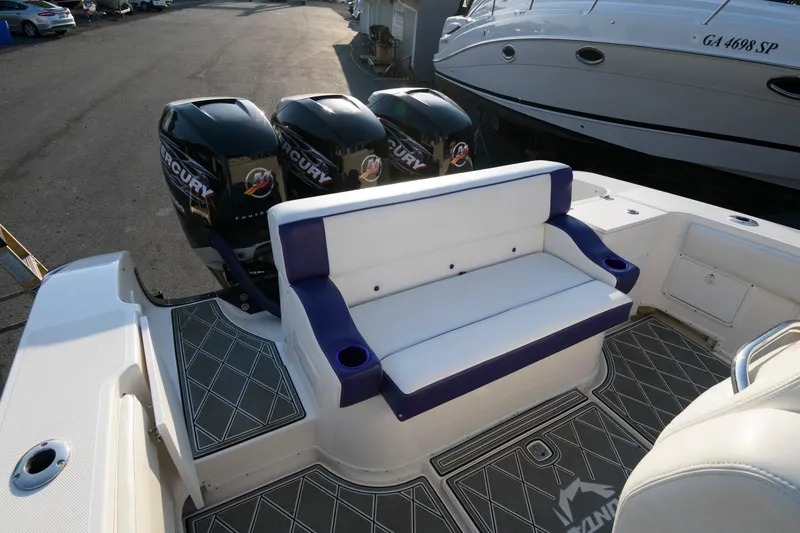 Slide: The Image of 2003 Fountain 38 Center Console boat with triple Mercury engines and cushioned seating. - 18