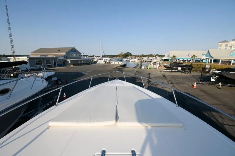 Slide: The Image of 2003 Fountain 38 Center Console boat docked at a marina with clear blue skies. - 23