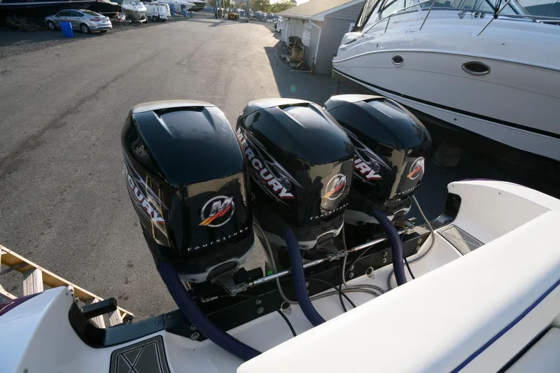 Slide: The Image of Triple Mercury outboard engines on a 2003 Fountain 38 Center Console boat. - 24