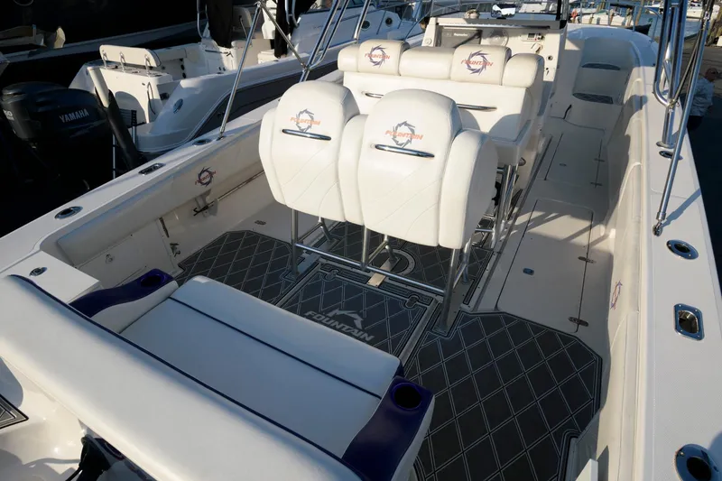 Slide: The Image of 2003 Fountain 38 Center Console boat interior with cushioned seating and sleek design. - 8