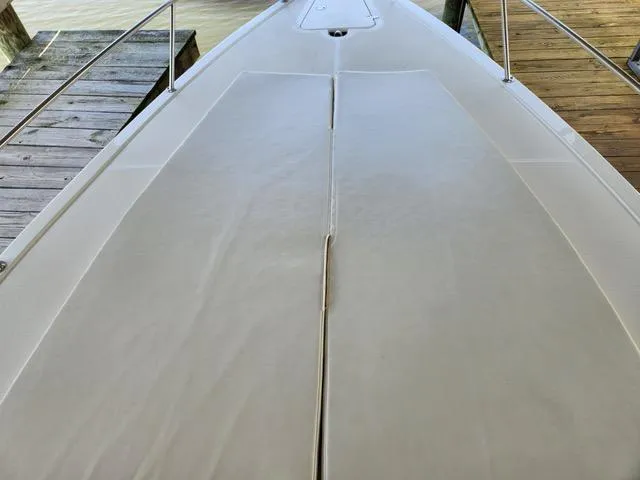 Slide: The Image of 2003 Fountain 38 Center Console boat deck, docked by wooden pier. - 9