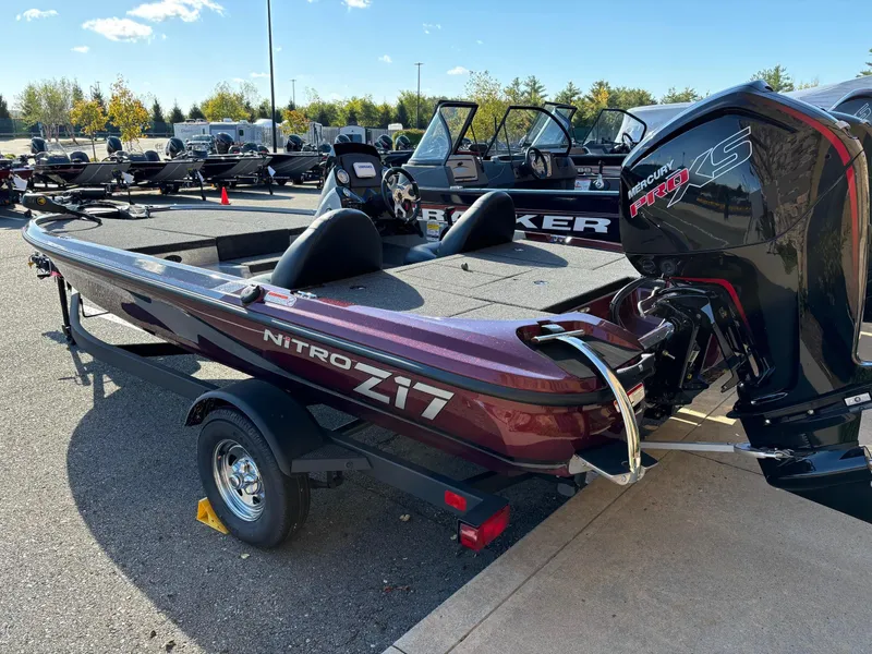 Slide: The Image of 2025 Nitro Z17 boat with Mercury Pro XS engine on a trailer in a parking lot. - 2