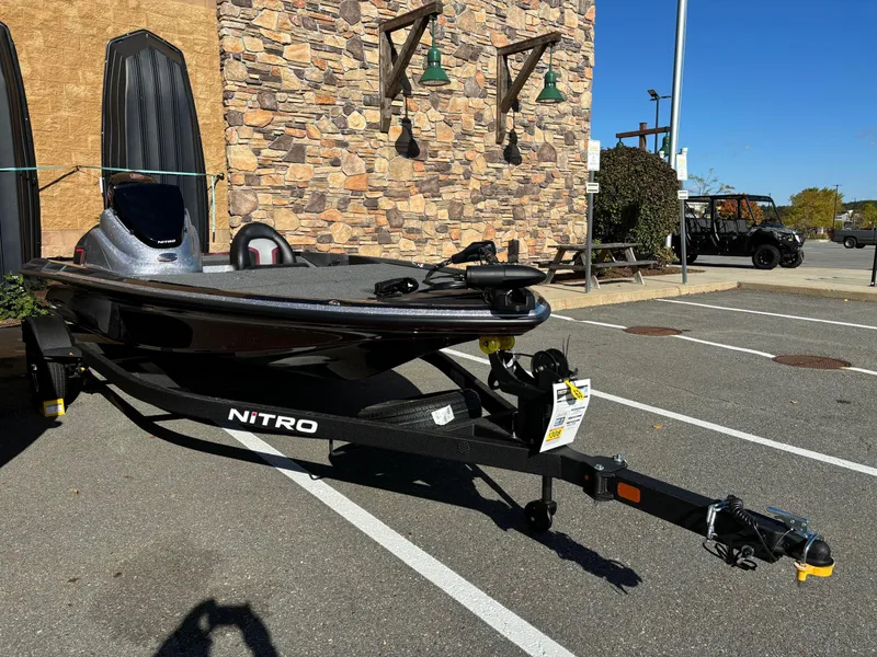 Slide: The Image of 2025 Nitro Z17 boat on trailer in parking lot, sunny day. - 3