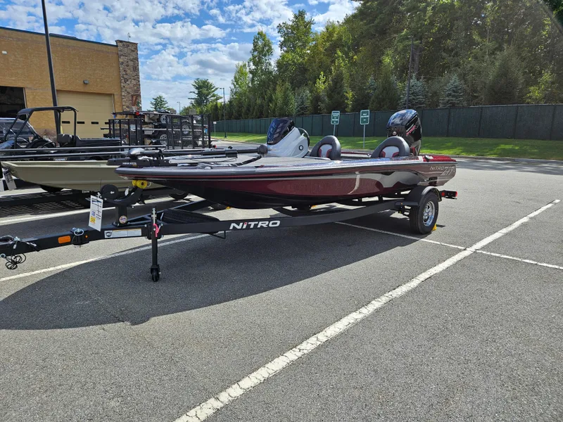 Slide: The Image of 2025 Nitro Z17 boat on trailer in parking lot, sunny day. - 4