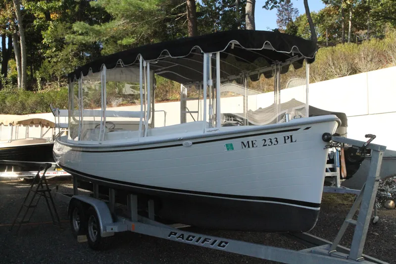 Slide: The Image of 2020 Duffy Suncruiser 22 boat on trailer, black canopy, parked outdoors. - 3