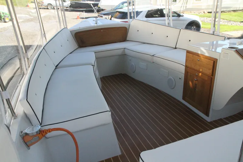 Slide: The Image of 2020 Duffy Suncruiser 22 interior with white seating and wood accents. - 6