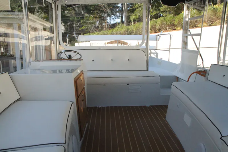 Slide: The Image of 2020 Duffy Suncruiser 22 interior with white seating and wooden flooring. - 7