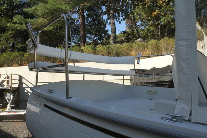 Slide: The Image of 2020 Duffy Suncruiser 22 boat docked outdoors, surrounded by trees and greenery. - 8