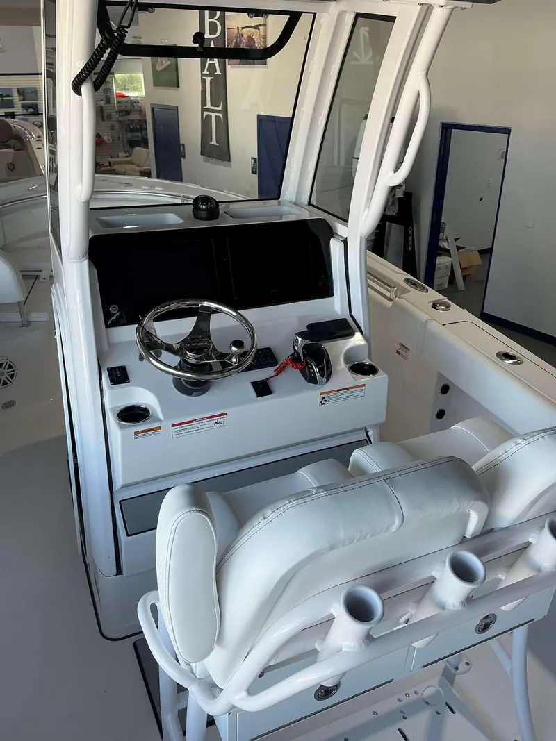 Slide: The Image of 2025 Sportsman 232 Open boat interior with steering console and seating. - 11