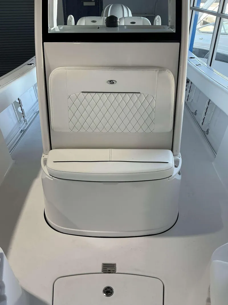 Slide: The Image of 2025 Sportsman 232 Open boat interior with white seating and storage compartment. - 14
