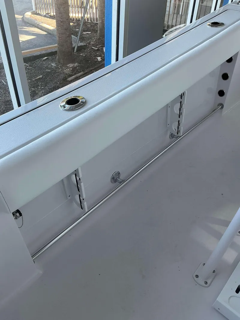 Slide: The Image of 2025 Sportsman 232 Open boat interior with rod holders and seating. - 4