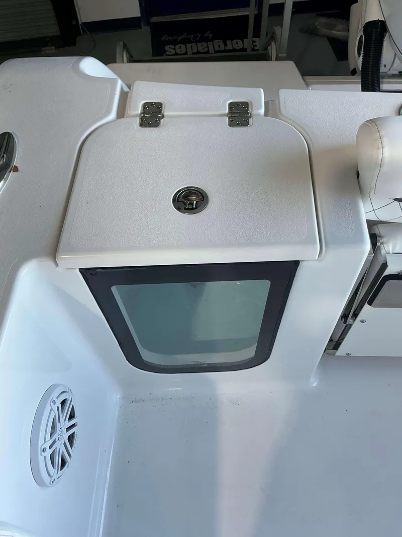 Slide: The Image of Sportsman 232 Open 2025 boat interior with storage compartment and speaker. - 5