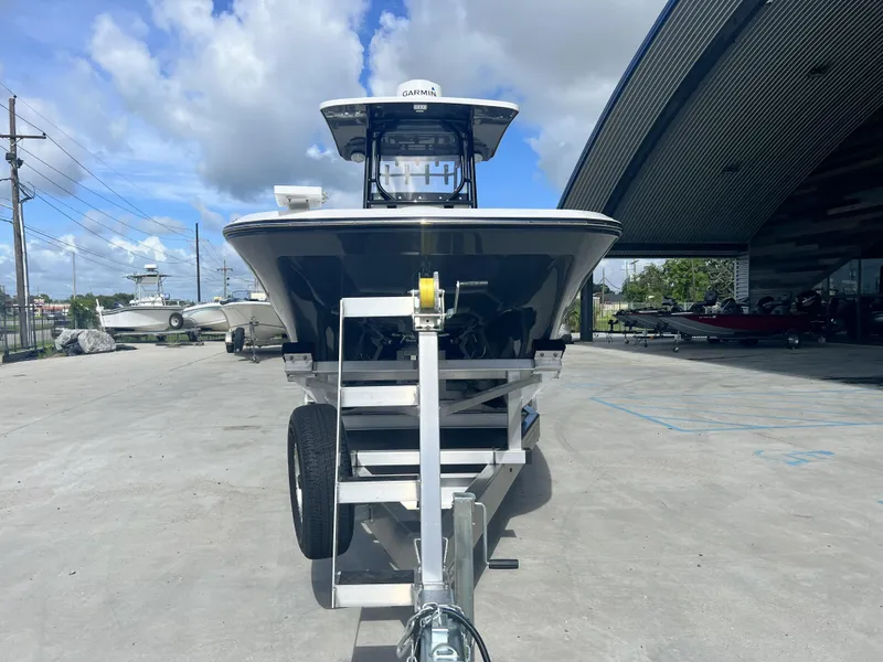 Slide: The Image of 2023 Sea Cat 260 HC boat on trailer, parked outdoors under a cloudy sky. - 2