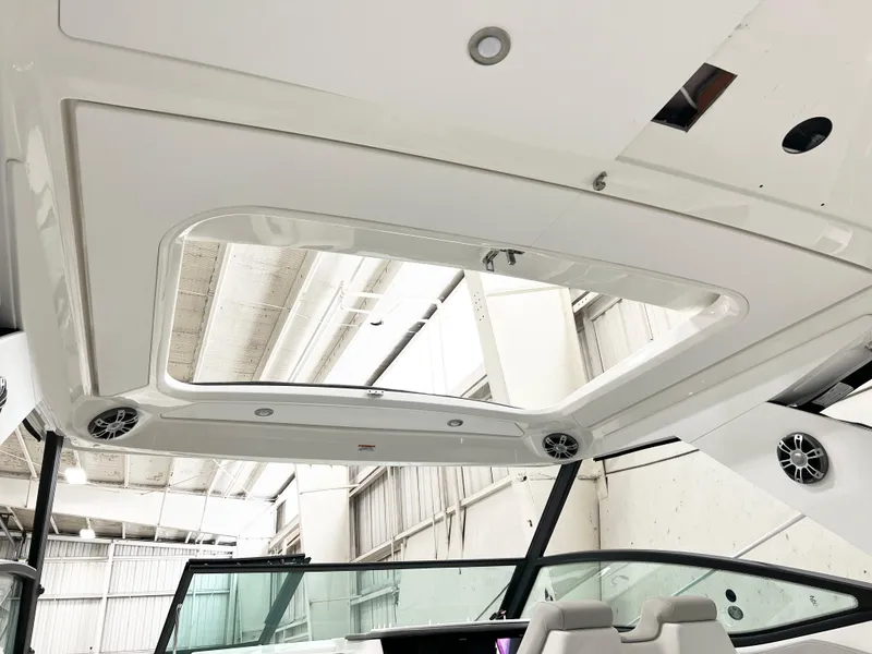 Slide: The Image of 2025 Sea Ray Sundancer 320 interior roof with skylight and speakers. - 12