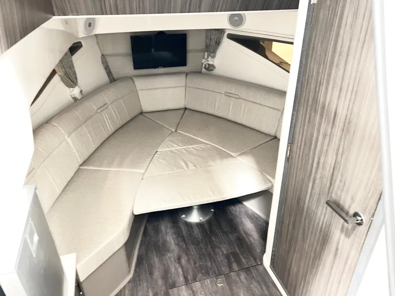 Slide: The Image of 2025 Sea Ray Sundancer 320 cabin interior with plush seating and modern design. - 13