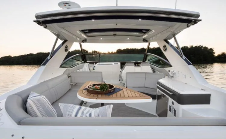 Slide: The Image of 2025 Sea Ray Sundancer 320 luxury yacht interior with elegant seating and table. - 16