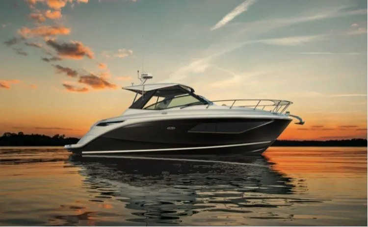 Slide: The Image of 2025 Sea Ray Sundancer 320 yacht at sunset on calm water. - 17