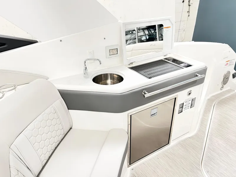 Slide: The Image of 2025 Sea Ray Sundancer 320 yacht interior with kitchenette and seating area. - 5