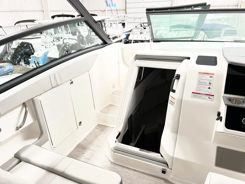 Slide: The Image of 2025 Sea Ray Sundancer 320 interior with open cabin door, showcasing sleek design. - 8