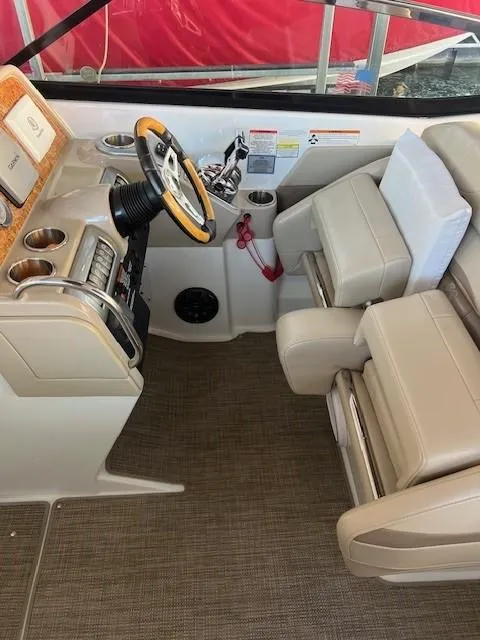 Slide: The Image of Interior of 2012 Formula 310 Bowrider I/O boat with beige seating and steering wheel. - 14