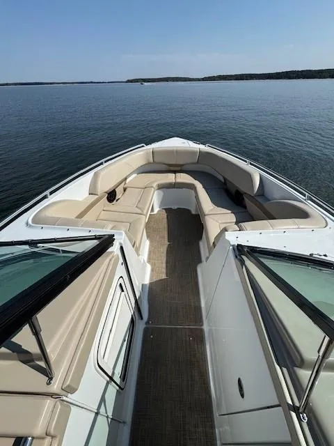 Slide: The Image of 2012 Formula 310 Bowrider I/O on calm water, featuring spacious seating and sleek design. - 17
