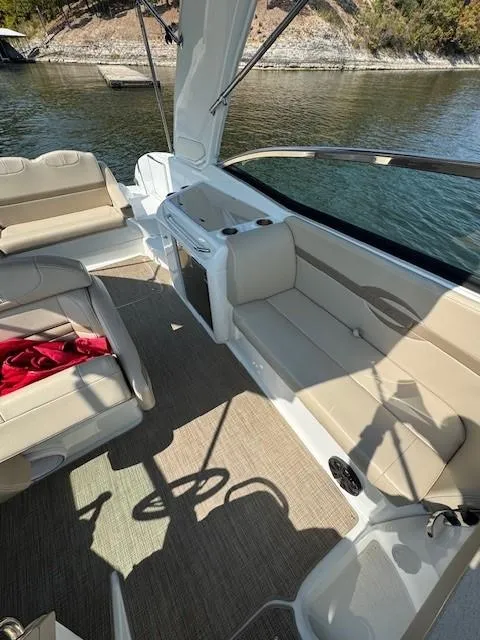Slide: The Image of 2012 Formula 310 Bowrider I/O interior with beige seating and lake view. - 19
