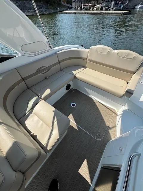 Slide: The Image of 2012 Formula 310 Bowrider I/O boat interior with beige seating, dockside view. - 20