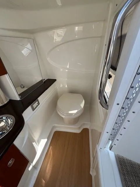 Slide: The Image of 2012 Formula 310 Bowrider I/O boat bathroom with modern fixtures and wood flooring. - 24