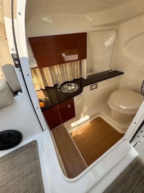 Slide: The Image of 2012 Formula 310 Bowrider I/O boat interior with compact bathroom and sink. - 25