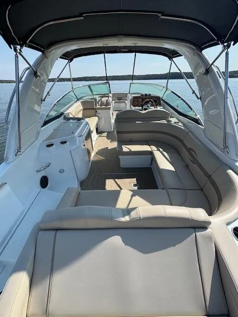 Slide: The Image of 2012 Formula 310 Bowrider I/O with spacious seating and canopy on a sunny day. - 27