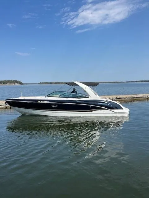 Slide: The Image of 2012 Formula 310 Bowrider I/O on calm water under clear blue sky. - 3