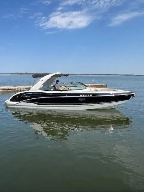 Slide: The Image of 2012 Formula 310 Bowrider I/O boat on calm water under a clear sky. - 9