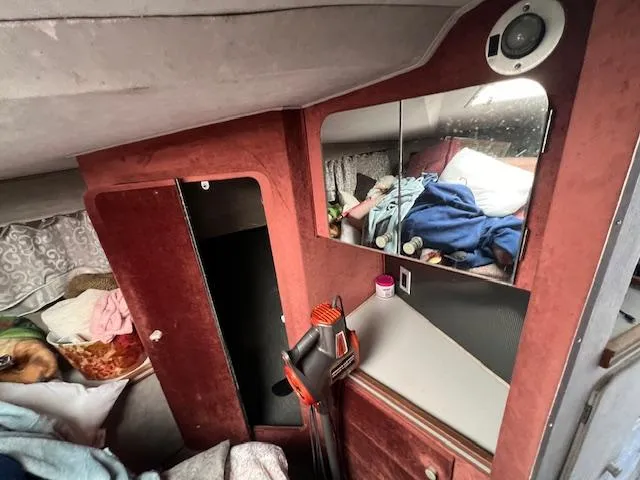 Slide: The Image of Interior of a 1985 Trojan 11 Meter Express boat with cozy cabin features. - 11