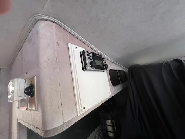 Slide: The Image of Interior of a 1985 Trojan 11 Meter Express boat, featuring control panel and equipment. - 12