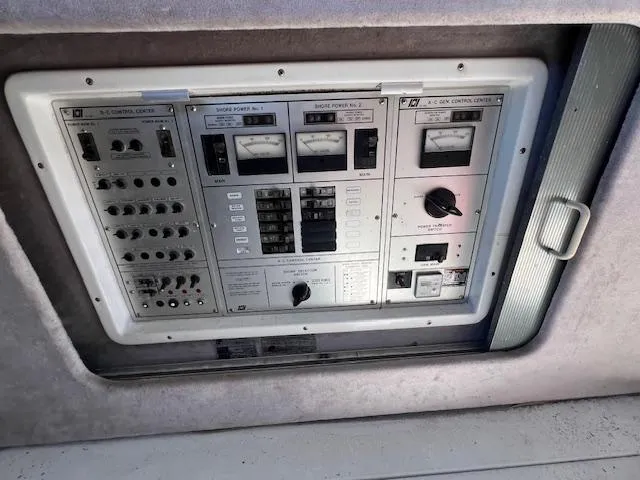 Slide: The Image of Control panel of a 1985 Trojan 11 Meter Express boat, featuring various switches and gauges. - 15