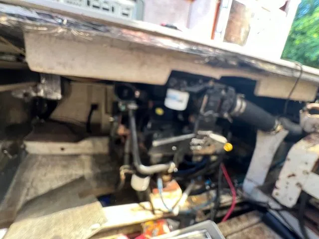 Slide: The Image of 1985 Trojan 11 Meter Express engine compartment with visible mechanical components and wiring. - 16