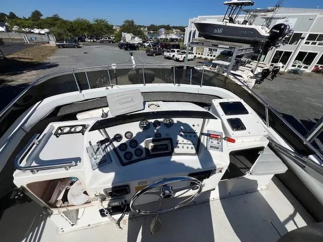 Slide: The Image of 1985 Trojan 11 Meter Express boat dashboard with steering wheel and control panels. - 20