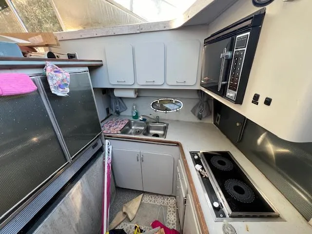 Slide: The Image of 1985 Trojan 11 Meter Express yacht kitchen with stove, microwave, and sink. - 7