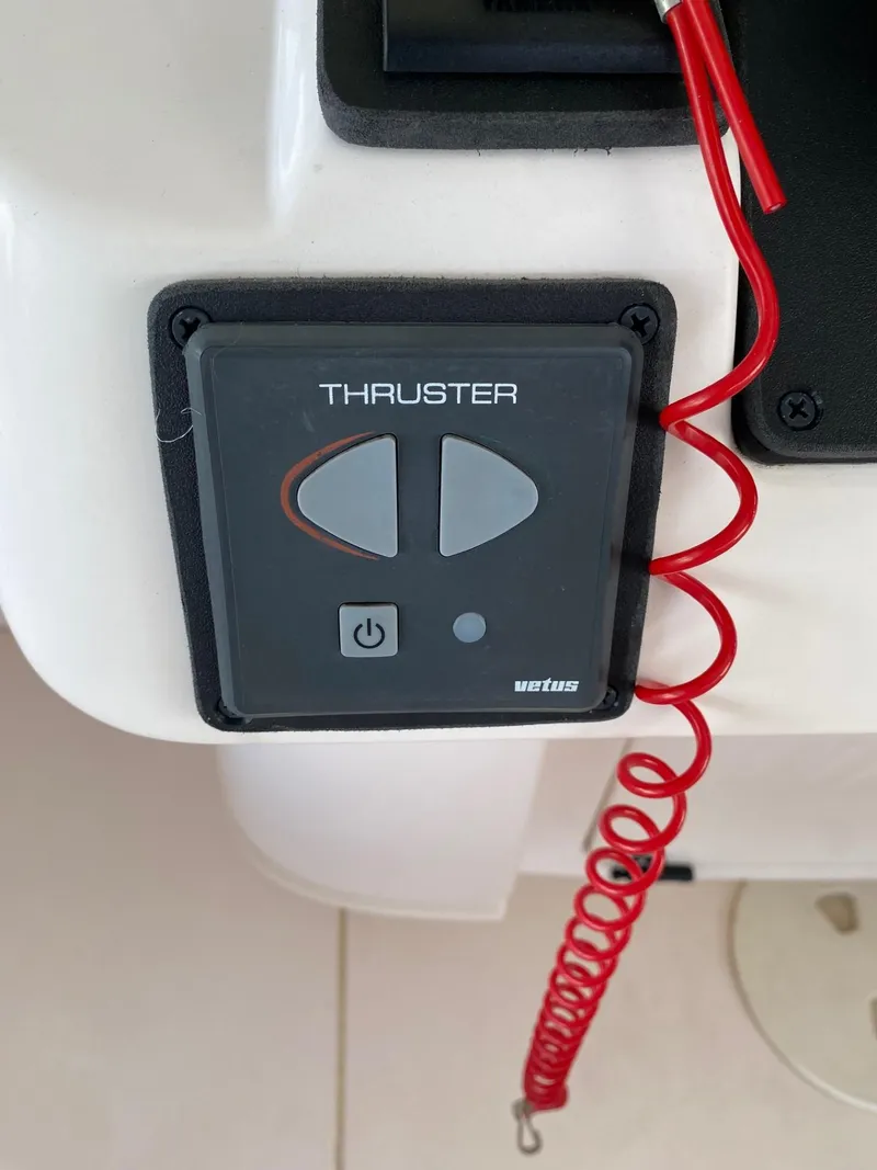 Slide: The Image of Intrepid 323 Cuddy 2002 thruster control panel with red safety cord. - 16