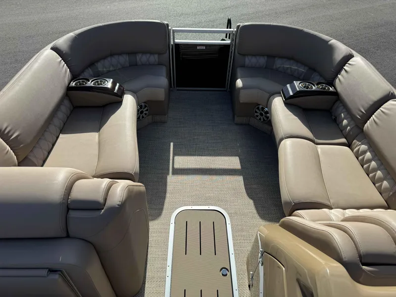 Slide: The Image of 2018 Bennington R25 boat interior with beige seating and cup holders. - 4