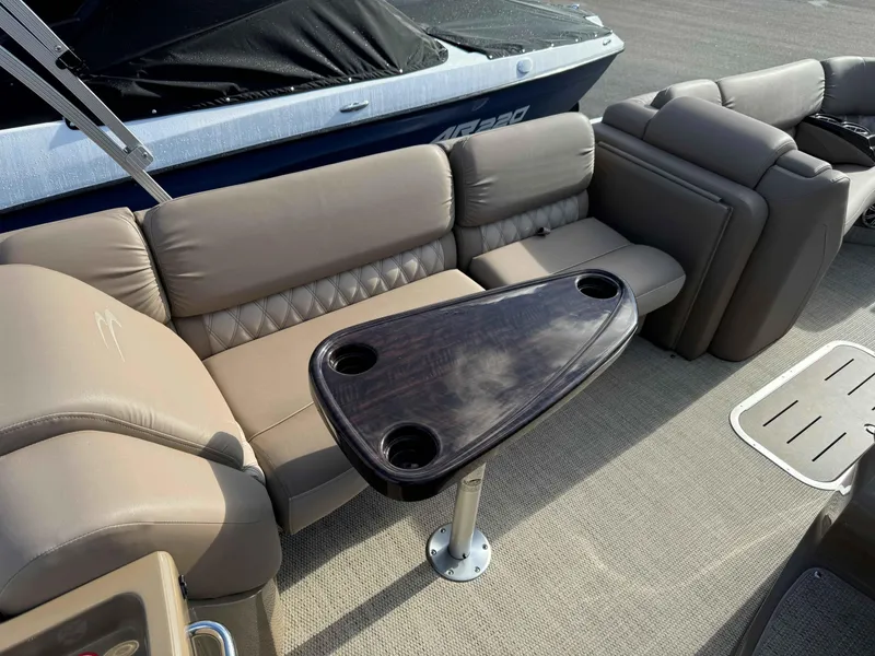 Slide: The Image of 2018 Bennington R25 boat interior with plush seating and a sleek table. - 5