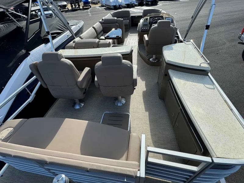 Slide: The Image of 2018 Bennington R25 pontoon boat interior with beige seating and helm station. - 7