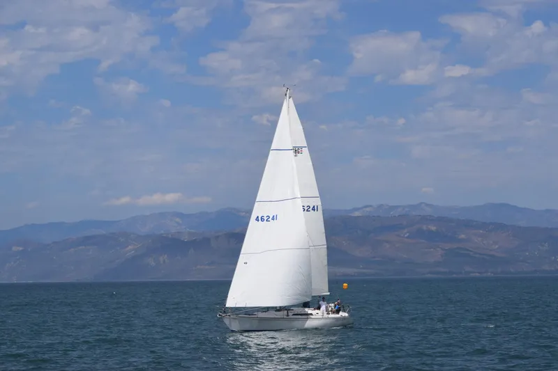 The Image of 1985 C&C 41 sailboat on open sea with mountain backdrop. - 0