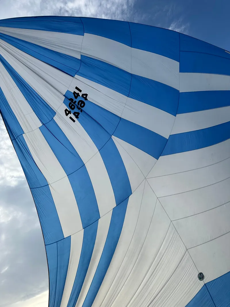 Slide: The Image of Blue and white striped sail of a 1985 C&C 41. - 24