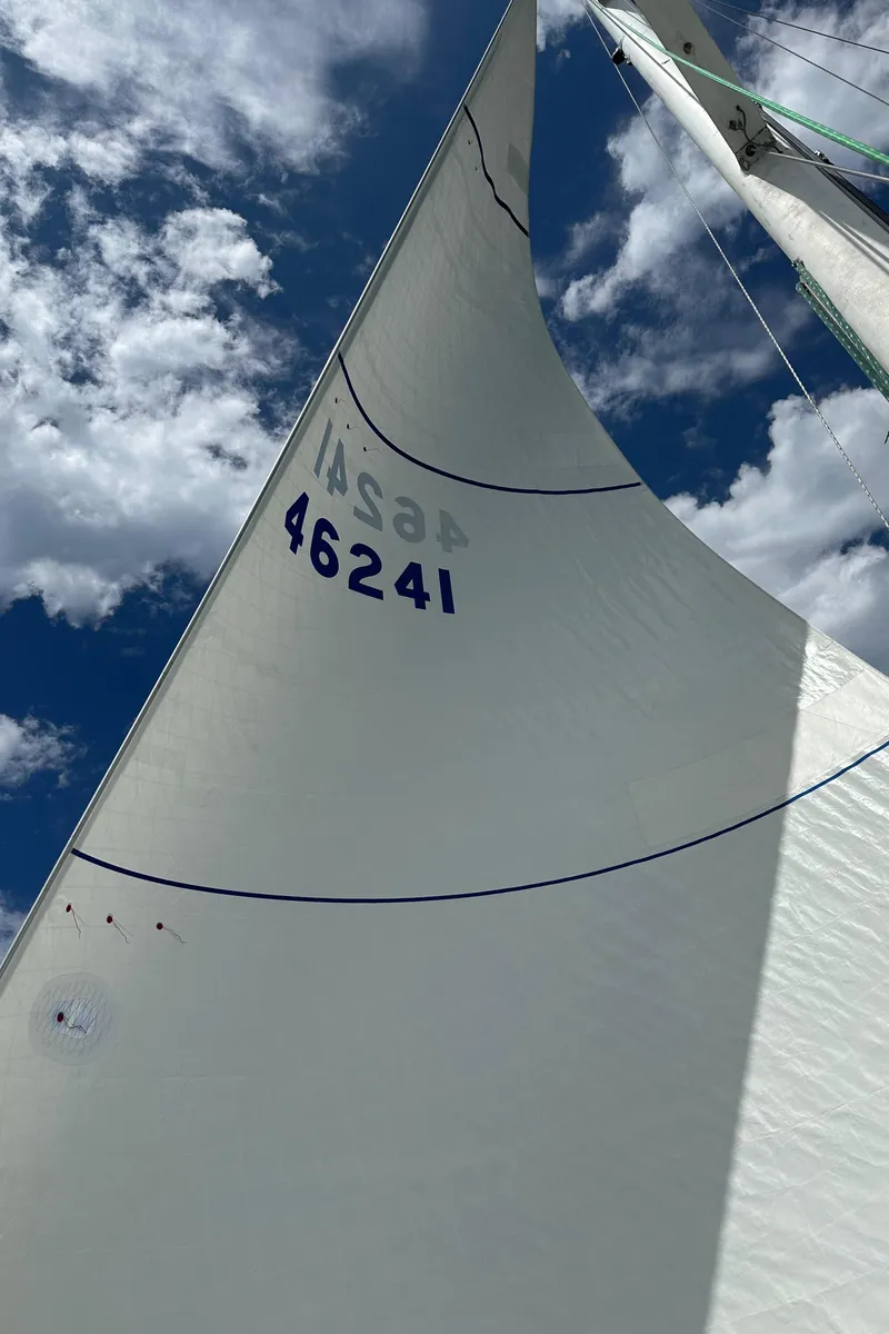 Slide: The Image of 1985 C&C 41 sailboat with sail number 46241 under blue sky. - 25